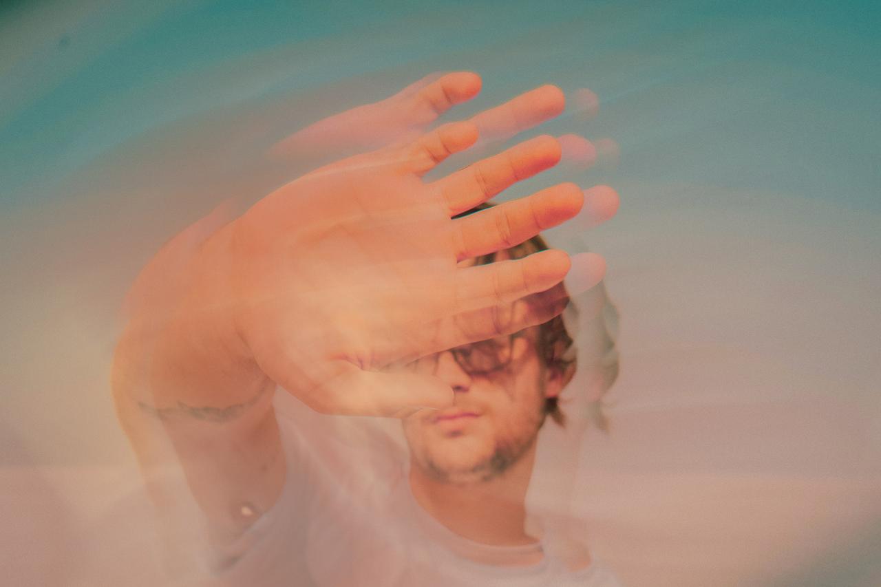 image of man with hand in front of his face in motion - shortlists uk awards iprospect 2025